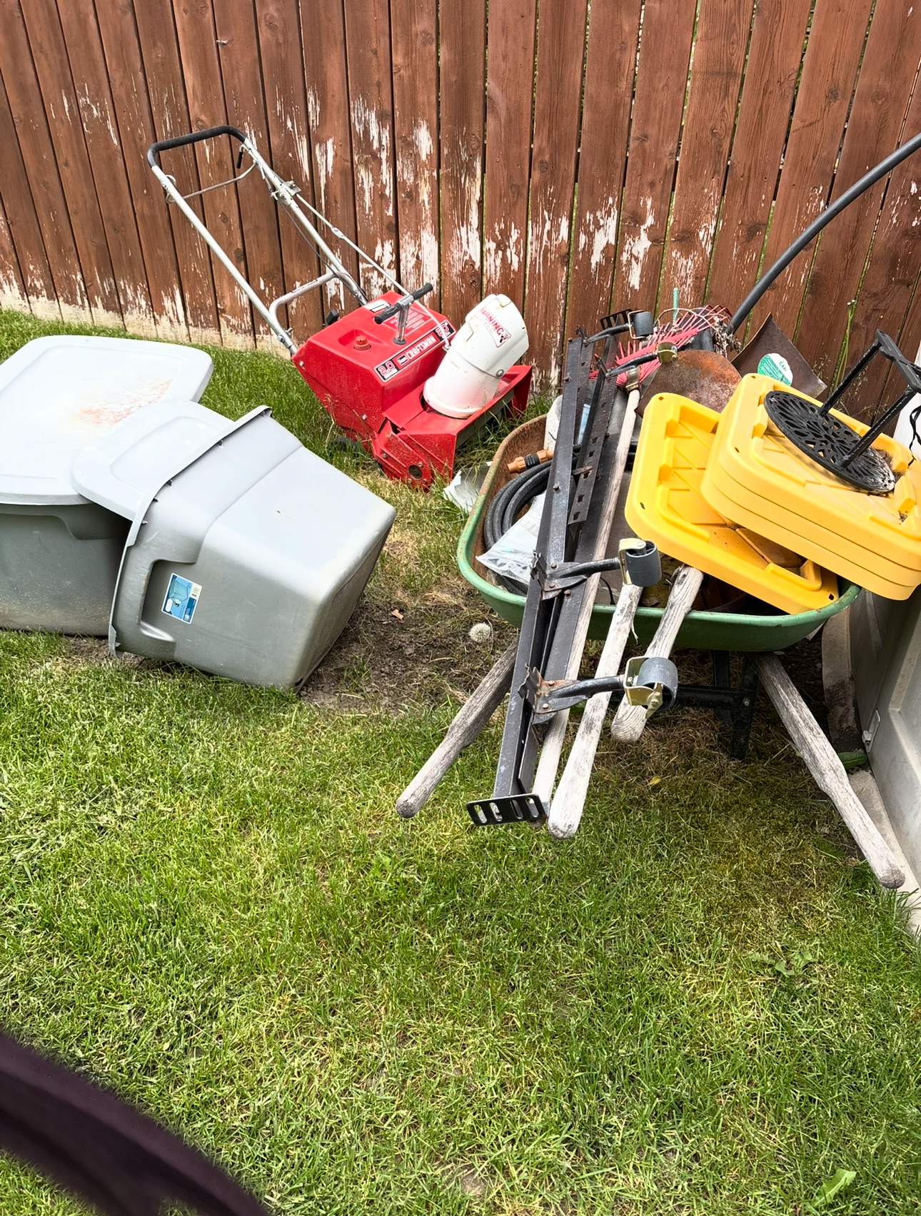 Before: Backyard cluttered with various equipment and tools